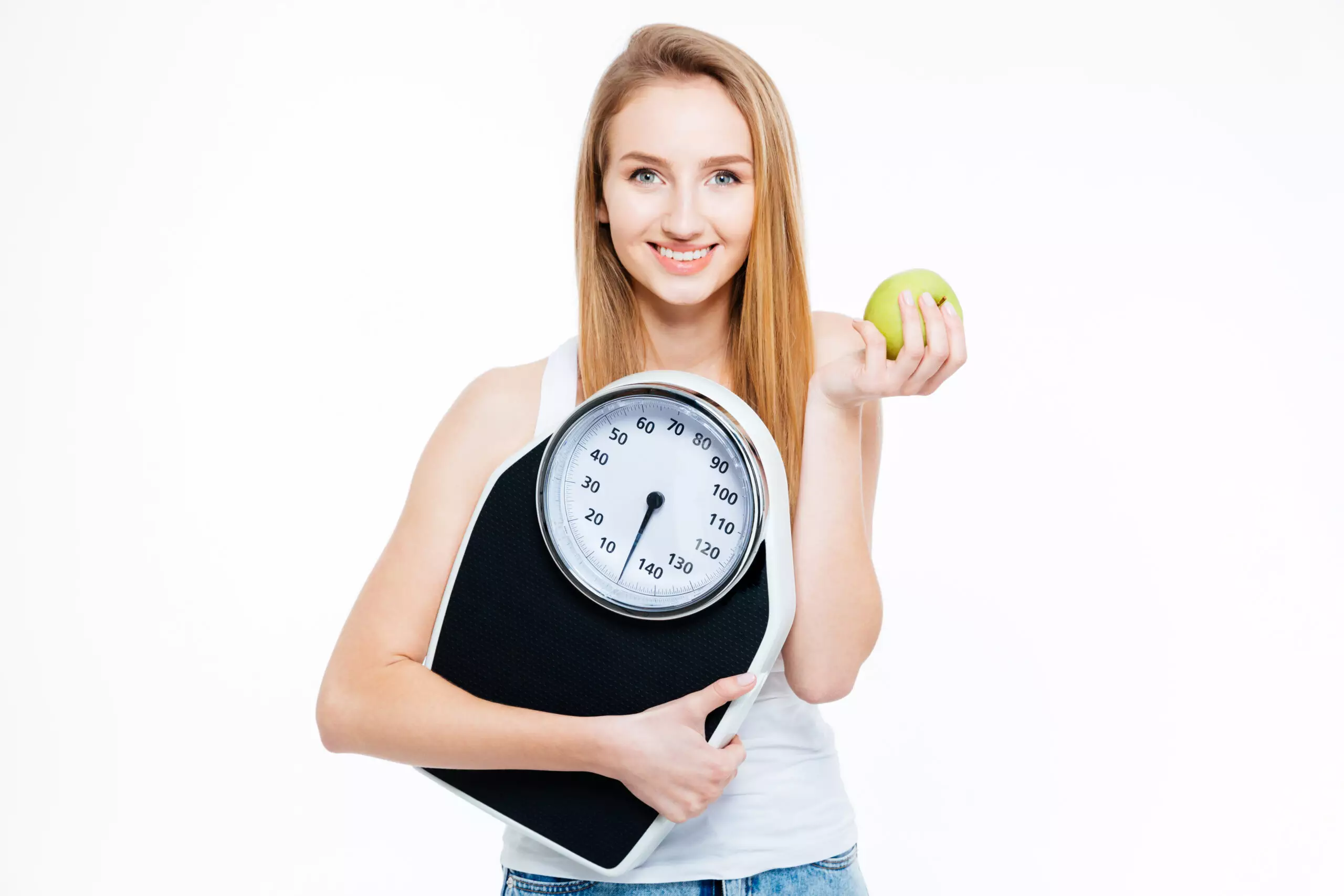 Woman holding scale and apple, symbolizing healthy lifestyle.